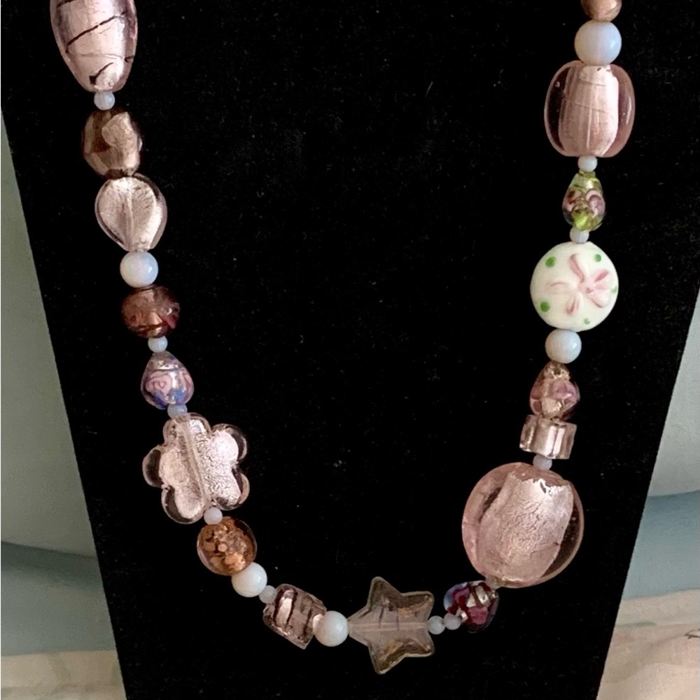 A hand crafted pink tone glass bead necklace